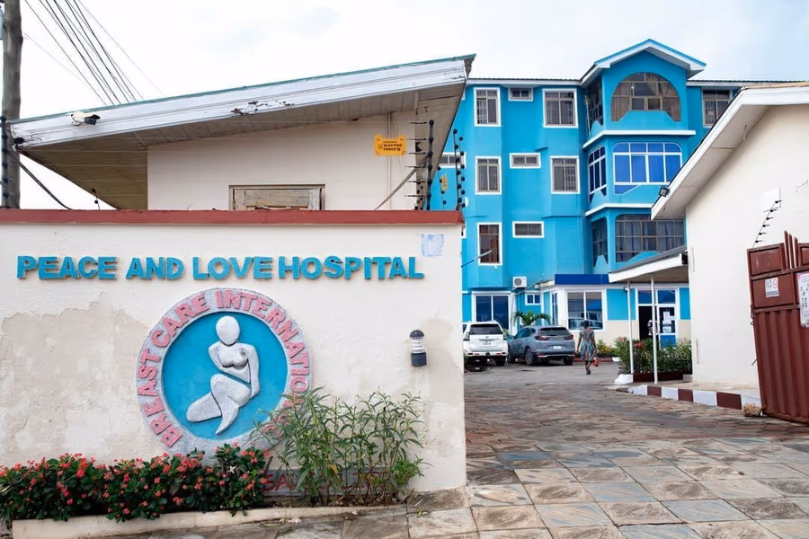 Peace and Love Hospital name on the Kumasi entrance wall.